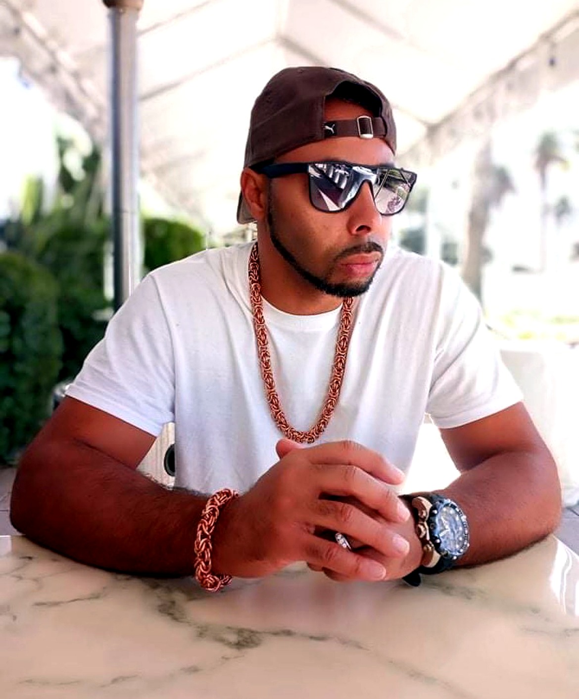 Baker, founder of Unique Equality, wearing his own hand-forged copper Byzantine chain